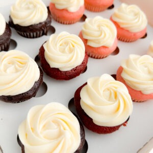 Colorful assortment of cupcakes featuring swirled vanilla frosting